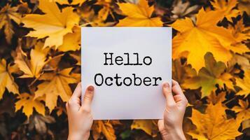 ai generado manos participación un sábana de papel con el palabra octubre en otoño hojas antecedentes foto