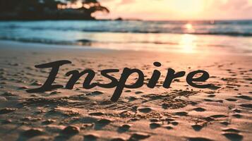 AI generated Inscription Inspire on the sand of a tropical beach at sunset photo