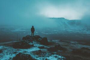 AI generated Silhouette of a man standing on top of a mountain in the fog. photo