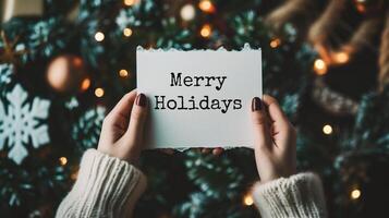 AI generated Merry Christmas lettering. Woman's hands holding a card with the text Merry Christmas. photo