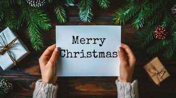 AI generated Merry Christmas and Happy New Year. Female hands holding white sheet of paper on the background of Christmas tree branches. photo