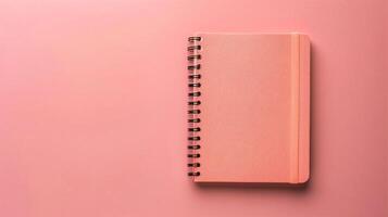 AI generated Notebook on pink background, top view, copy space for text photo