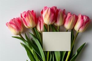 ai generado ramo de flores de rosado tulipanes con saludo tarjeta en blanco antecedentes foto