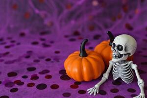 AI generated Halloween decoration with skeleton and pumpkins on purple background, copy space photo