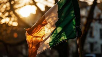 AI generated National flag of Ireland waving in the wind in the rays of the setting sun photo