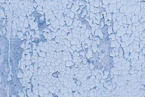 Blue texture of old cracked paint, grunge background. photo