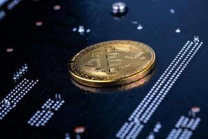 bitcoin physical shiner on black electronic board with selective focus and blur photo