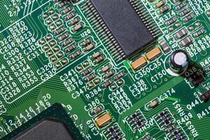 old digital circuit board with microprocessors and components, closeup full-frame macro background photo