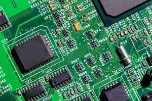 old digital circuit board with microprocessors and components, closeup full-frame macro background photo