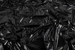 full frame abstract background of crumpled black plastic film bag photo