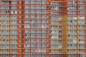 large russian cheap apartment building wall with enormous quantity of windows, full-frame background and texture photo