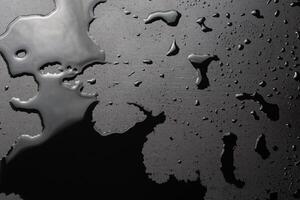 abstract background of wet black clean painted surface - close-up with selective focus photo