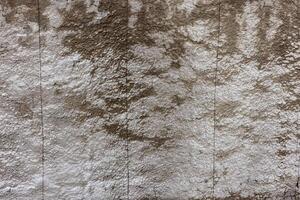 rough concrete wall with weathered texture effect and saw cuts photo