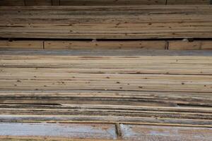 wooden boards storage under a canopy with snow and metled ice on the floor photo