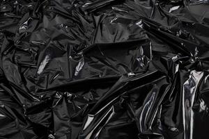 Fondo abstracto de fotograma completo de bolsa de película de plástico negro arrugado foto