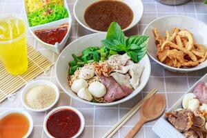 Thai boat noodles with Thai spices and ingredient on background. photo