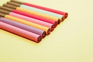 Multicolored cigarettes on a paper background, the concept of a bad habit. photo