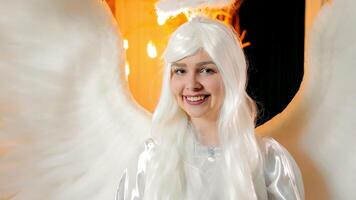 A smiling angel looking at the camera. Portrait and image of an angel with white wings video