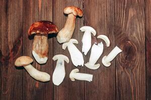 Boletus edulis on a table made of brown boards preparation for eating. photo