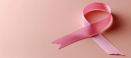 AI generated Pink ribbon   symbol of breast cancer awareness month on pink background with copy space photo