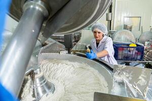 caucasion woman working in a food factory wearing protective clothes and gloves. photo