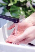 Hands wash procedure, cleaning hands with soap from viruses and contamination. Wash hands before dinner photo