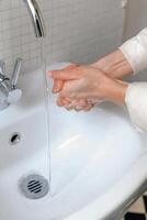 Hands wash procedure, cleaning hands with soap from viruses and contamination. Wash hands before dinner photo