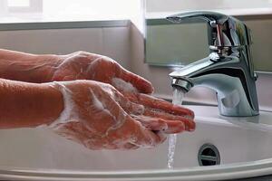 Hands wash procedure, cleaning hands with soap from viruses and contamination. Wash hands before dinner photo