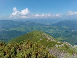 Mountains peak with green fields photo