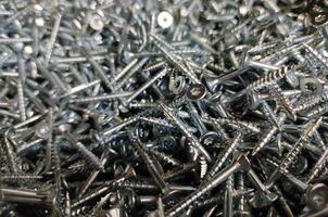 Screws close view, blurred construction elements, industrial abstract background photo