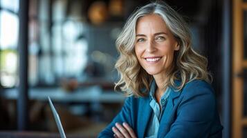 AI generated Smiling middle aged businesswoman in blue suit working on laptop at office desk with determination photo