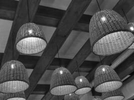 Black and white electric lamps and wooden ceiling background. Monochrome cafe photo wallpaper