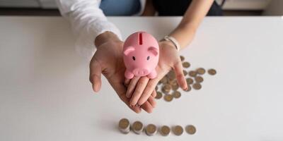 Happy couple asian saving while sitting together on desk at home, loving spouse plan budget and saving money for future photo