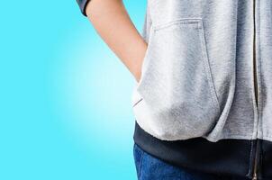 Hand in his pocket shirt on blue background. photo