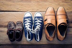 Three pairs of shoes, three stages of the growth. photo