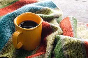 Coffee cups and scarves on a wooden table photo