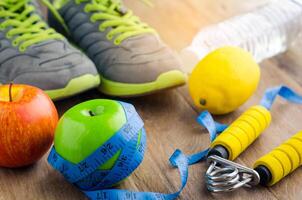 fitness concept with Exercise Equipment on wooden background. photo