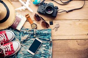 Travel accessories and costume on wooden floor photo