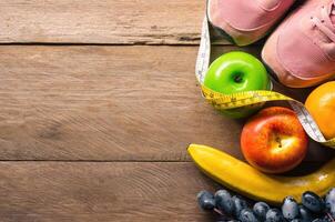 fitness concept with Exercise Equipment on wooden background. photo