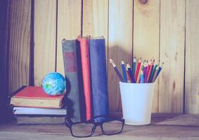 Still life color pencil and books on wooden background photo