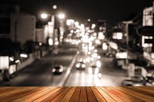 Wooden plank and blur cars traffic on urban street tone vintage photo