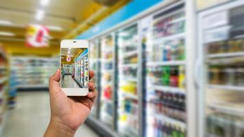 Hand holding smartphone on shopping mall photo