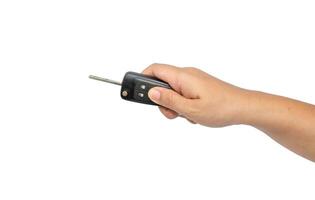 hand holding a car key isolated on white background photo