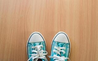 Blue sneakers on wood. photo