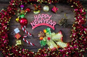 happy New Year message and gift box on wooden background. photo