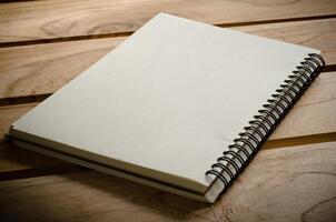 White notebooks laying on a wooden table photo