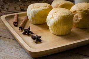 Bread platters and milk in glass on wooden floor. photo