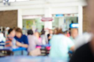 Blur image people enjoy different activities between meals in the cafeteria. photo