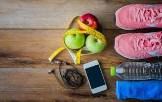 fitness concept with Exercise Equipment on wooden background. photo