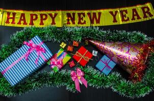 happy New Year message and  gift box on wooden background. photo